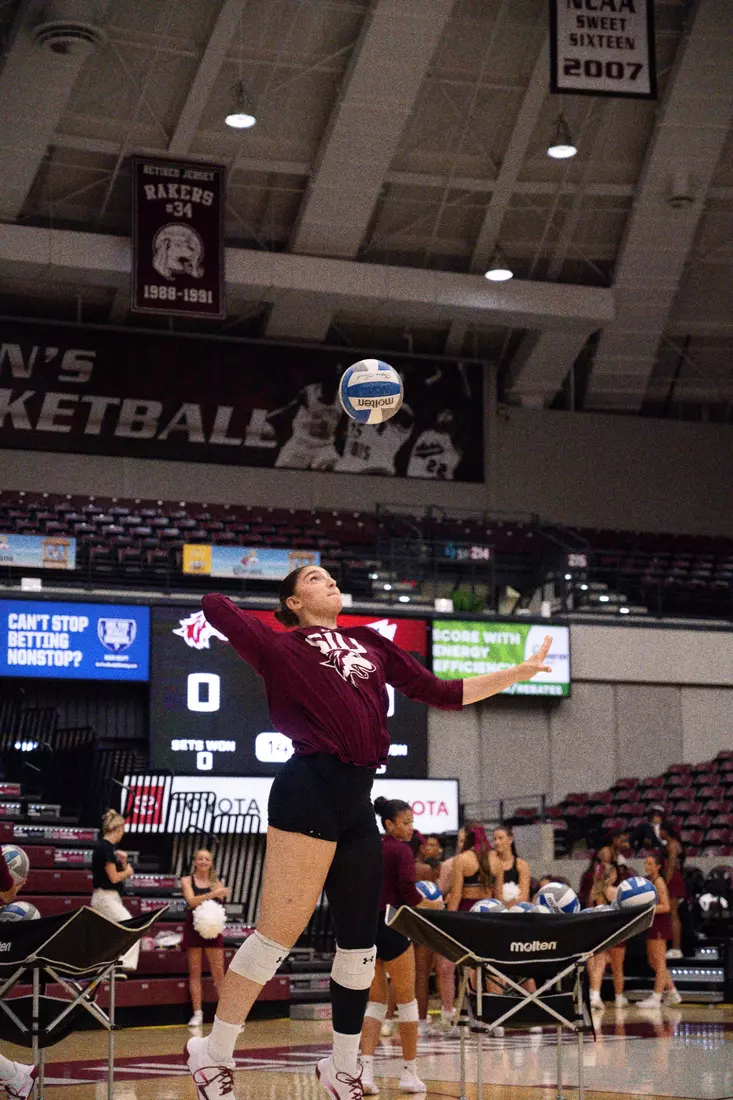 Una Stepic serves a ball in warmups.
