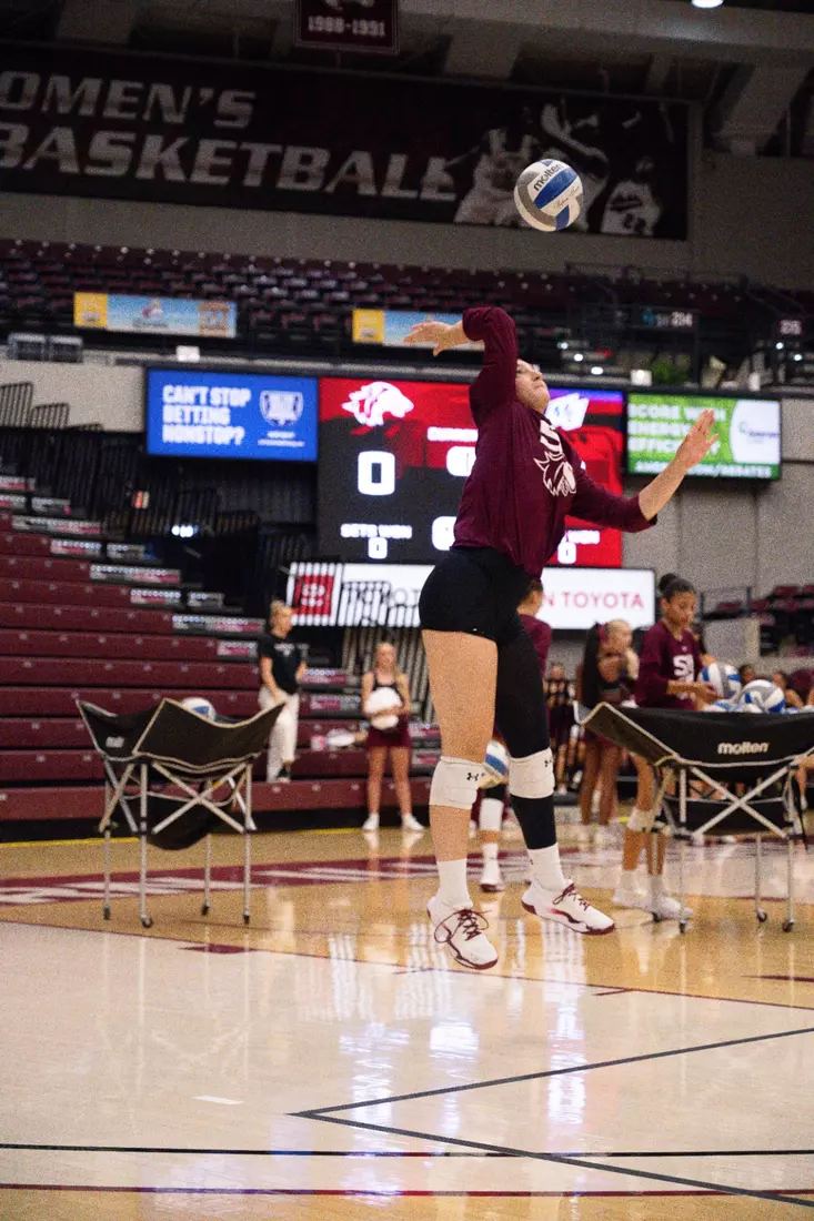 Una Stepic serves a ball in warmups.