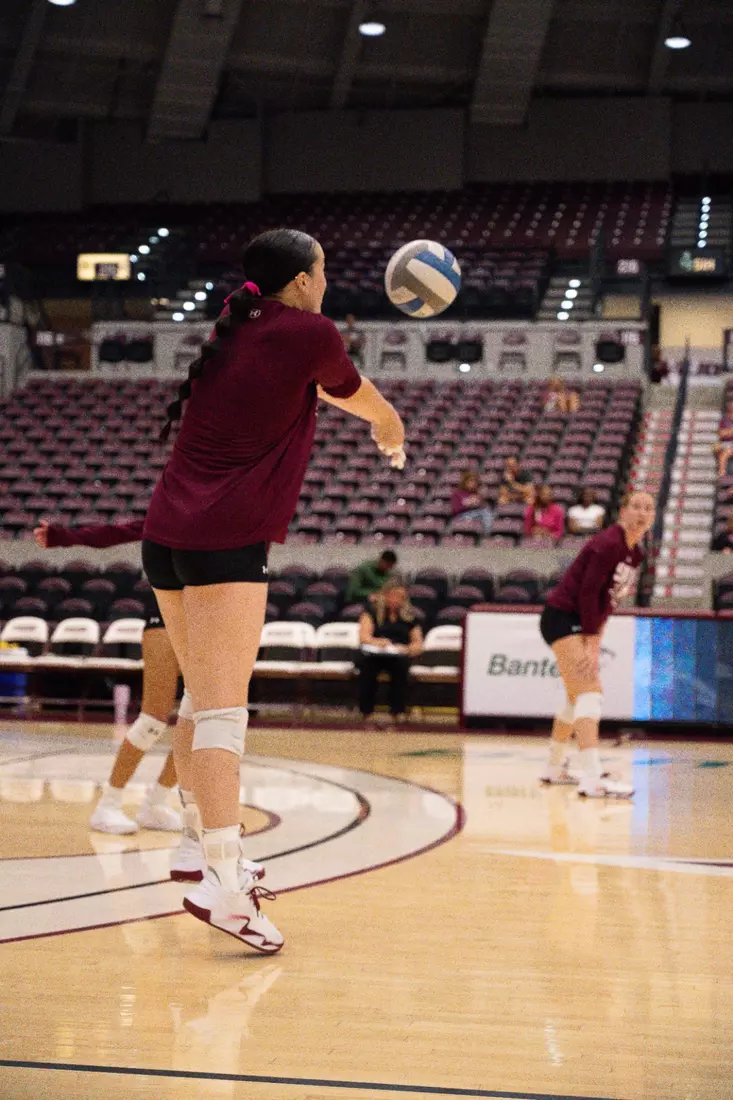 Alexandria Arrington bumps a ball in warmups.