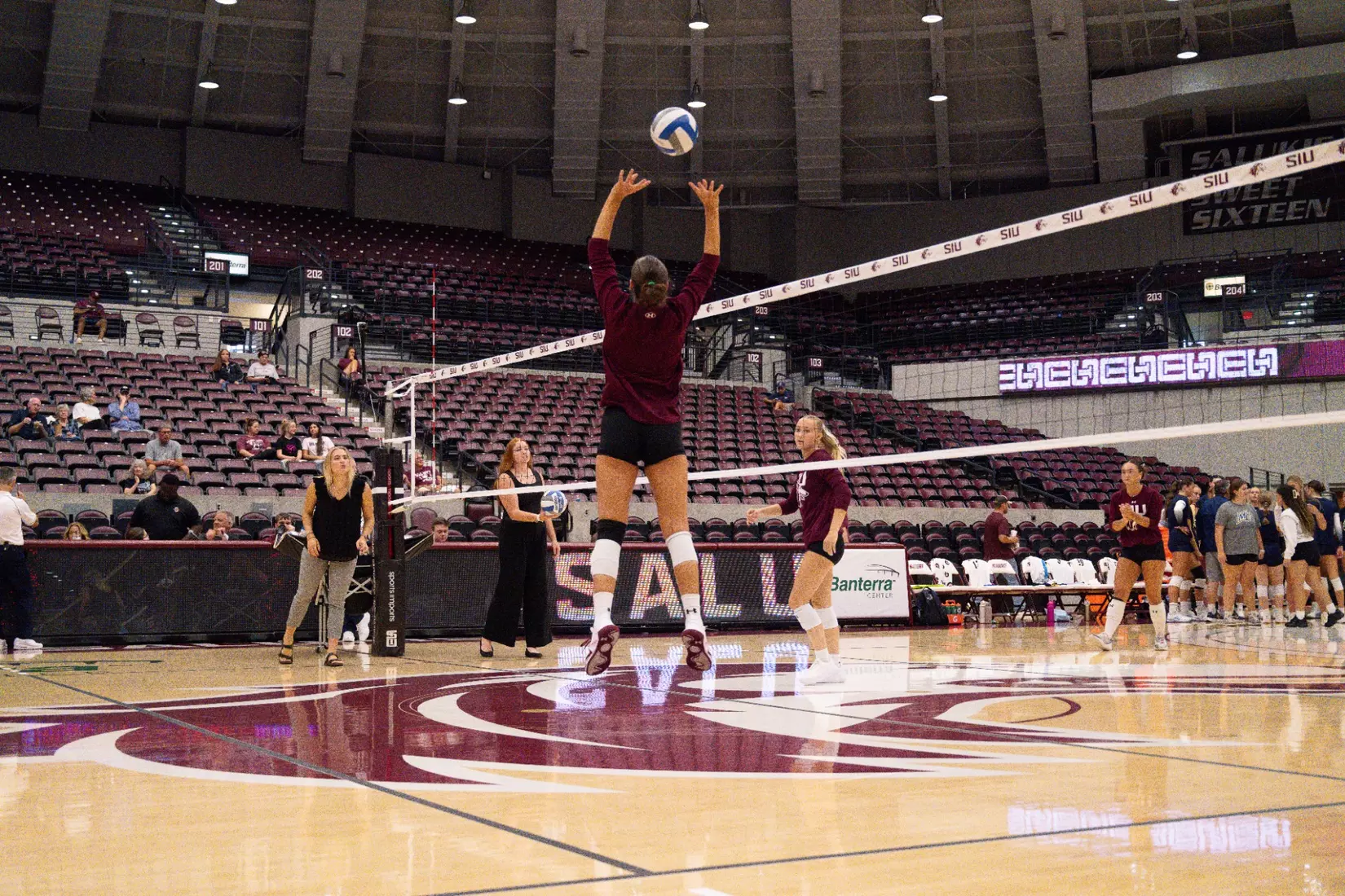 Ella McFarland sets a ball in warmups.