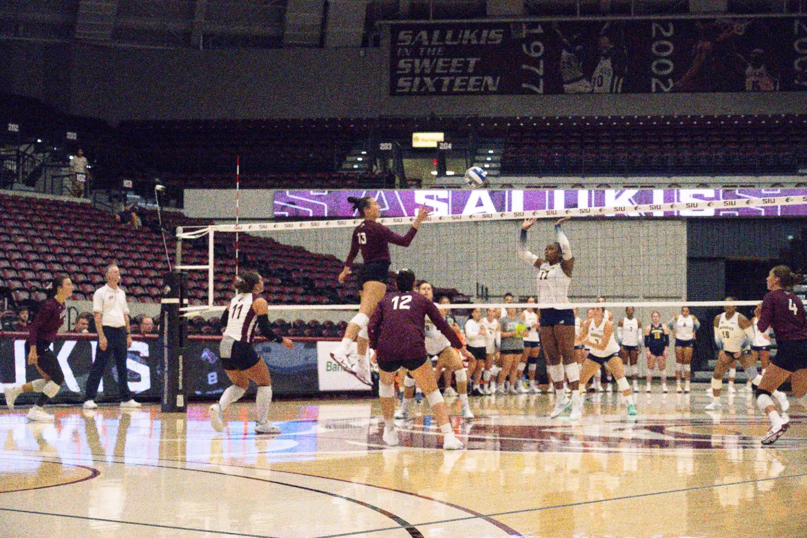 Beatriz Piaia tips a ball over the net.