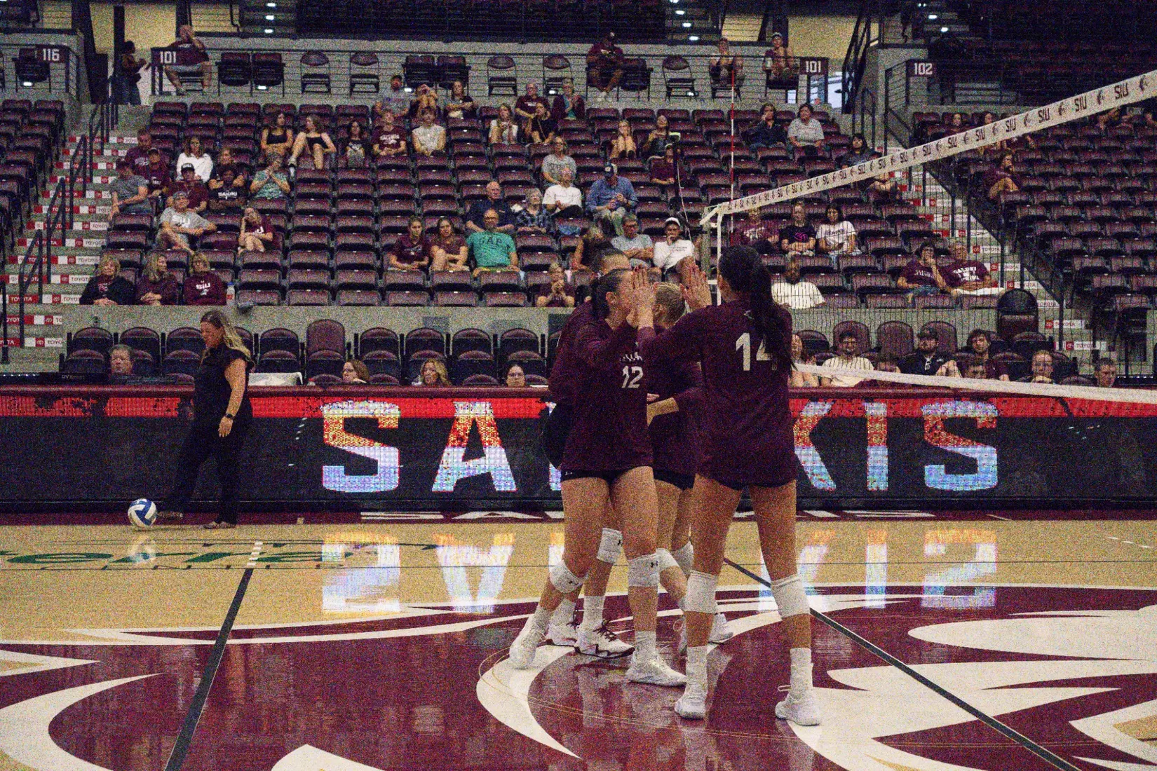 Carlota Mora and Ella Swansiger high five after a point.