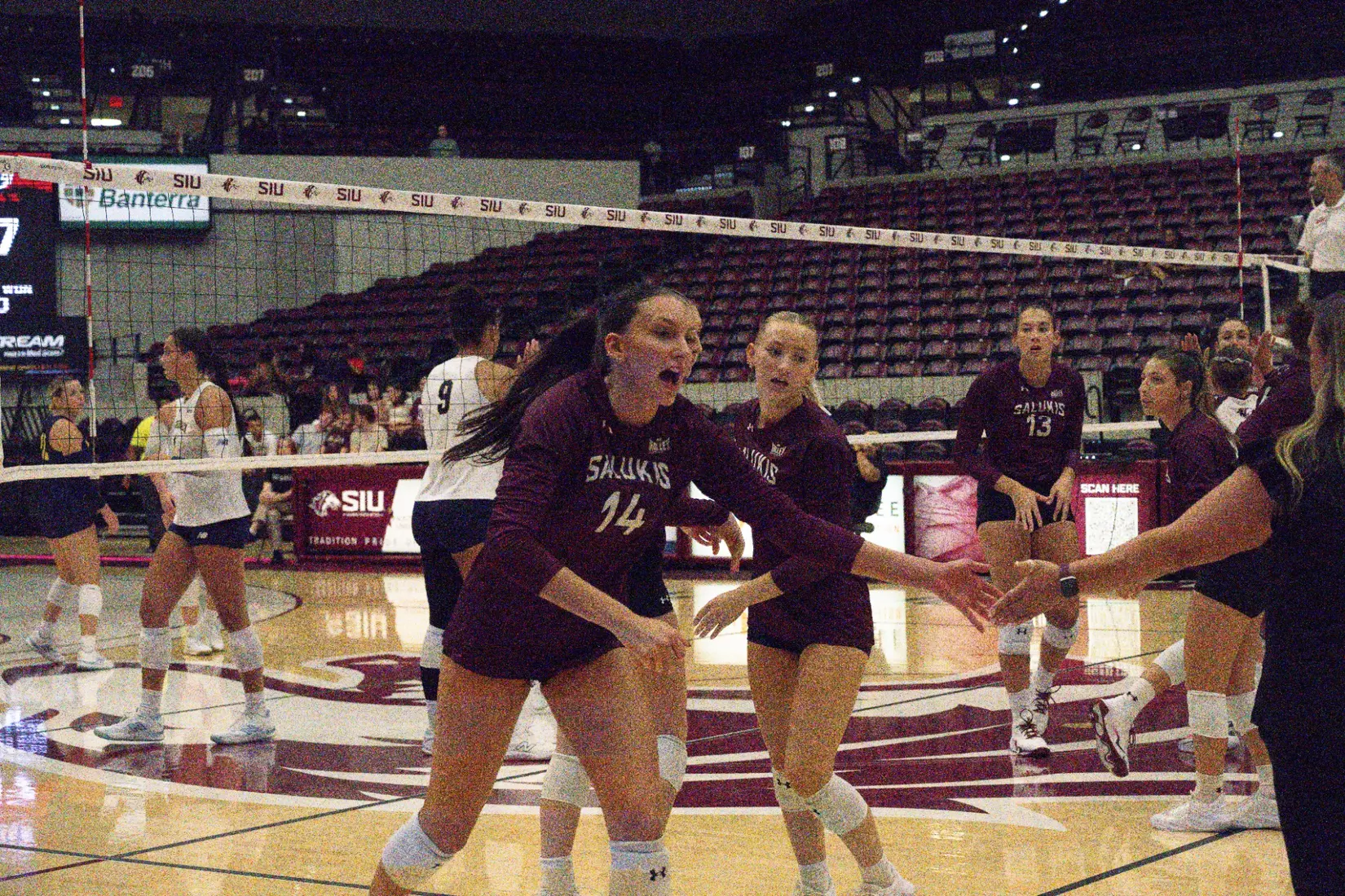 Ella Swansiger high fives head coach Brittany Harry.
