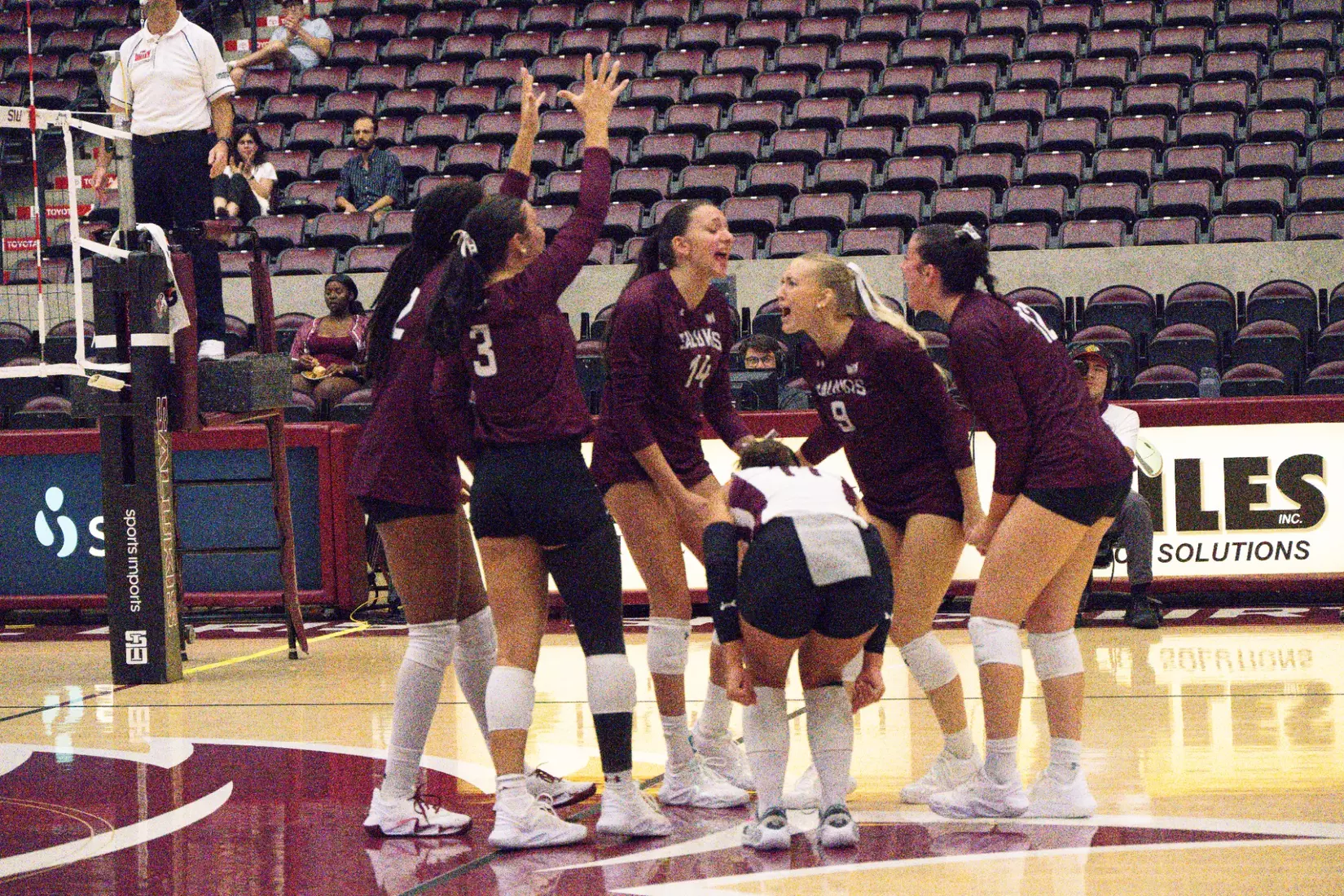 The team screams in celebration after a point.