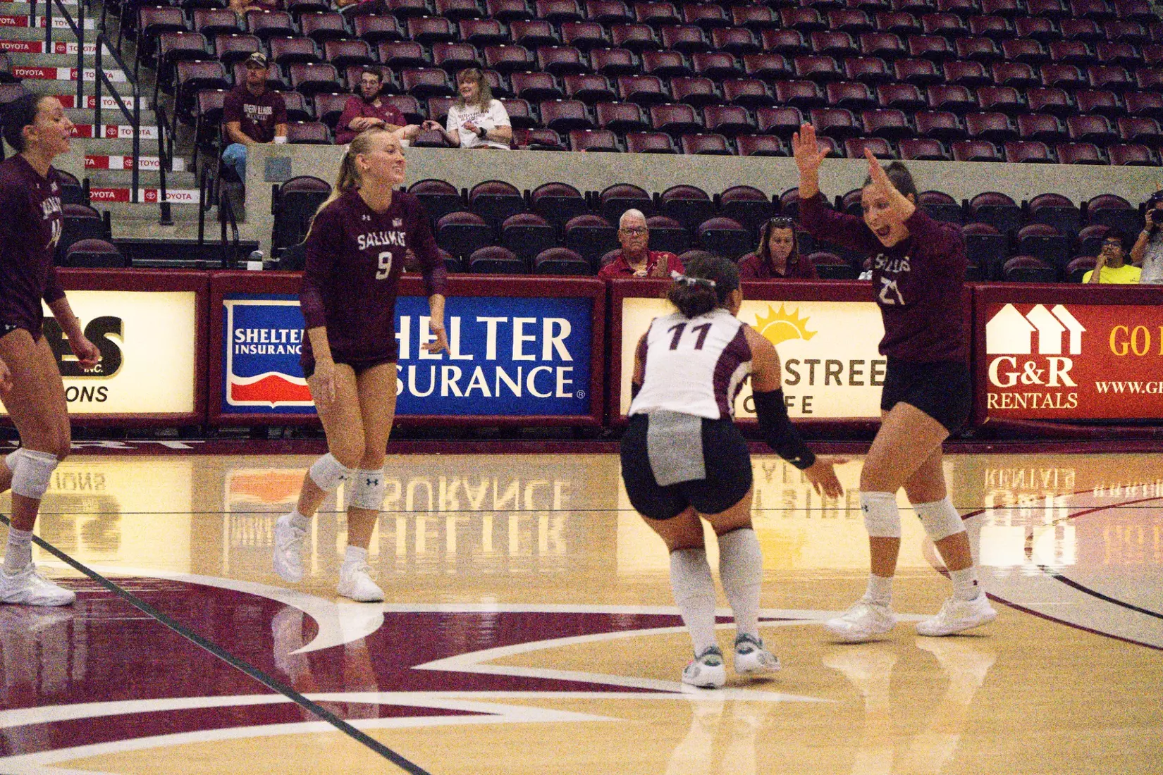Isabella Del Real and Jillian Shaneyfelt high five after a point.
