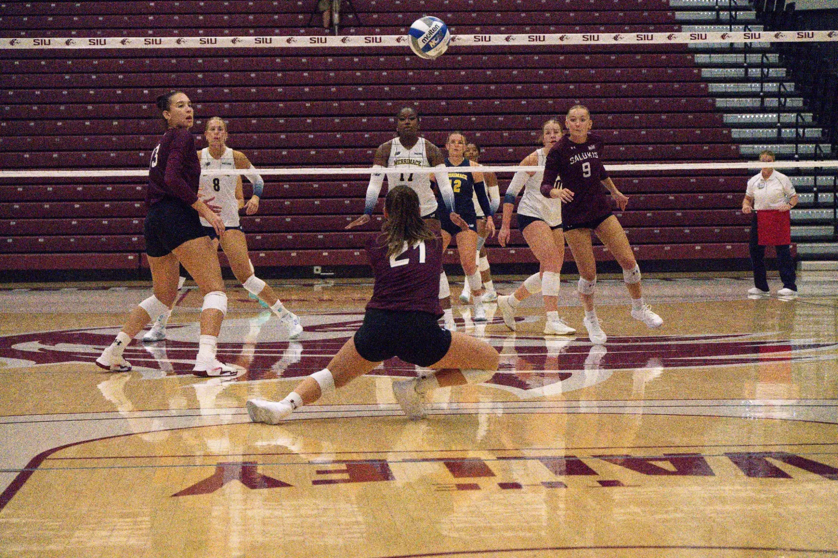 Isabella Del Real lunges as she bumps a ball.