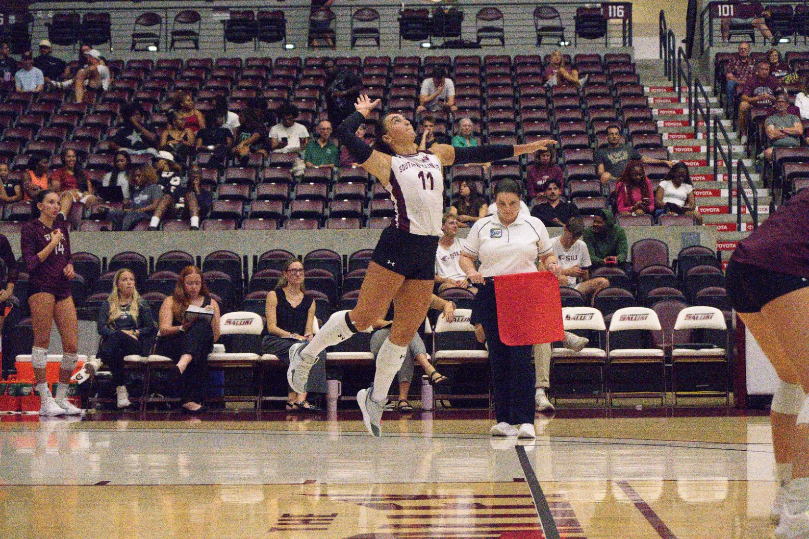 Jillian Shaneyfelt goes airborne for a serve.