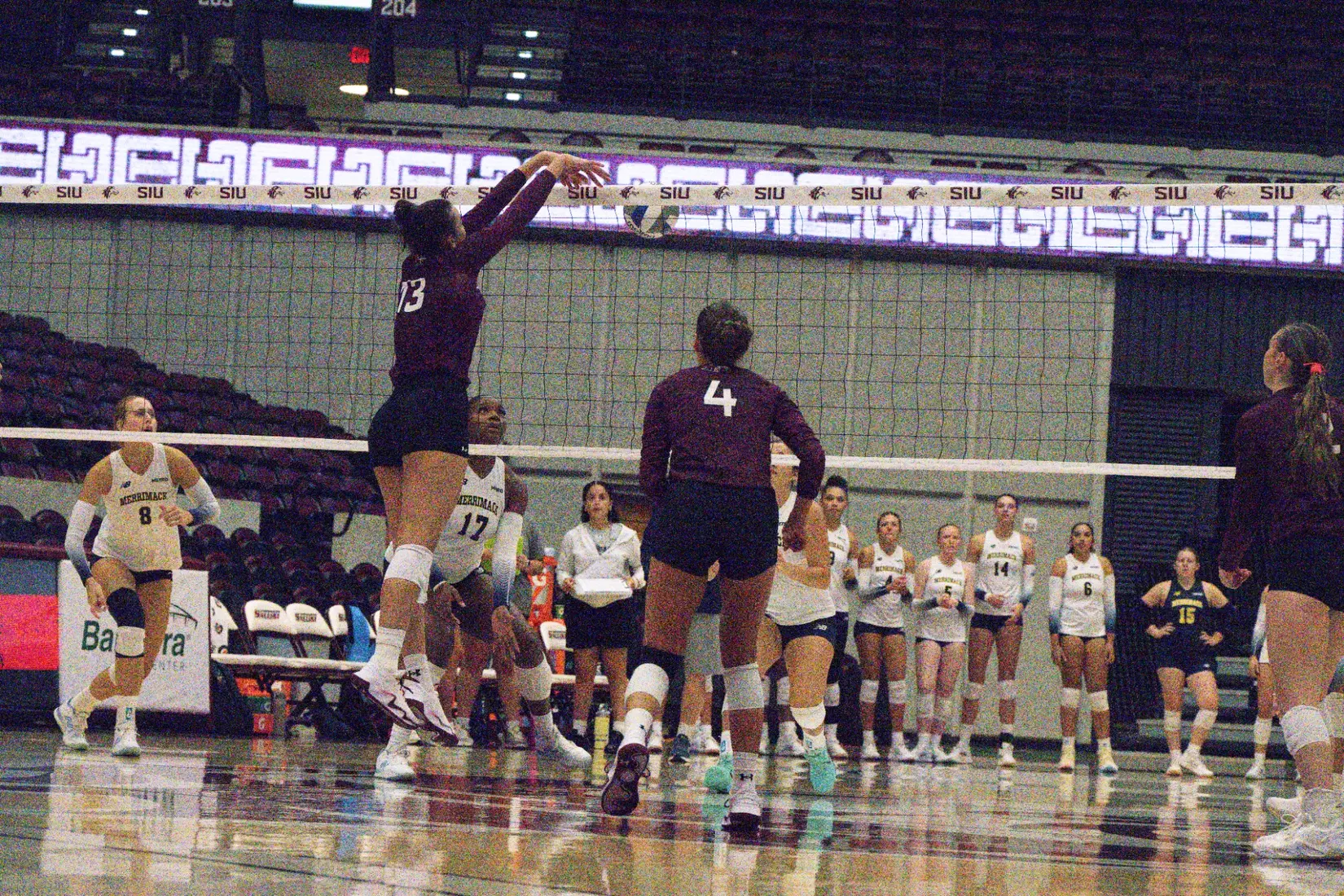 Beatriz Piaia tips a ball over the net.