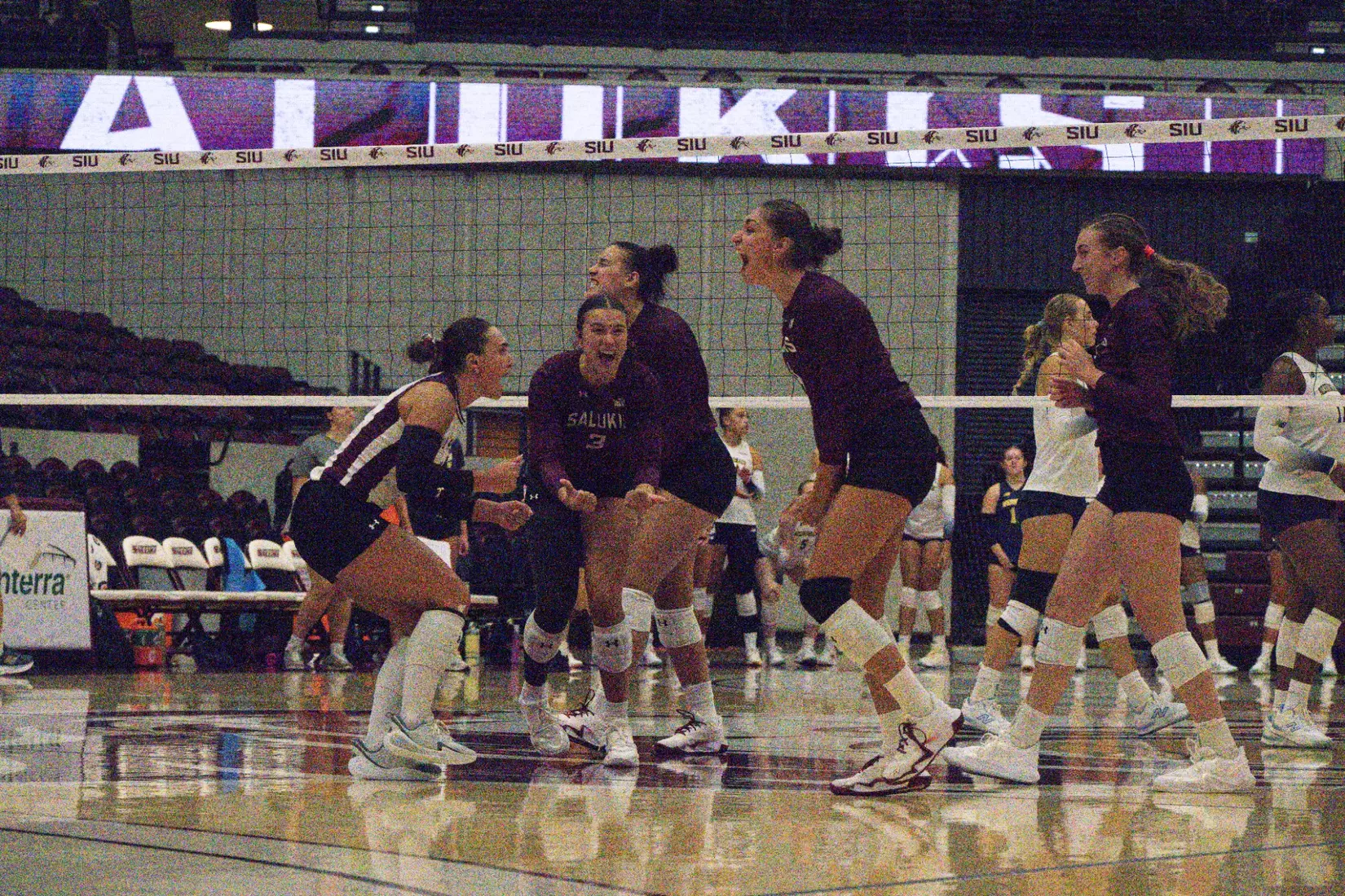 The team screams in celebration after a point.