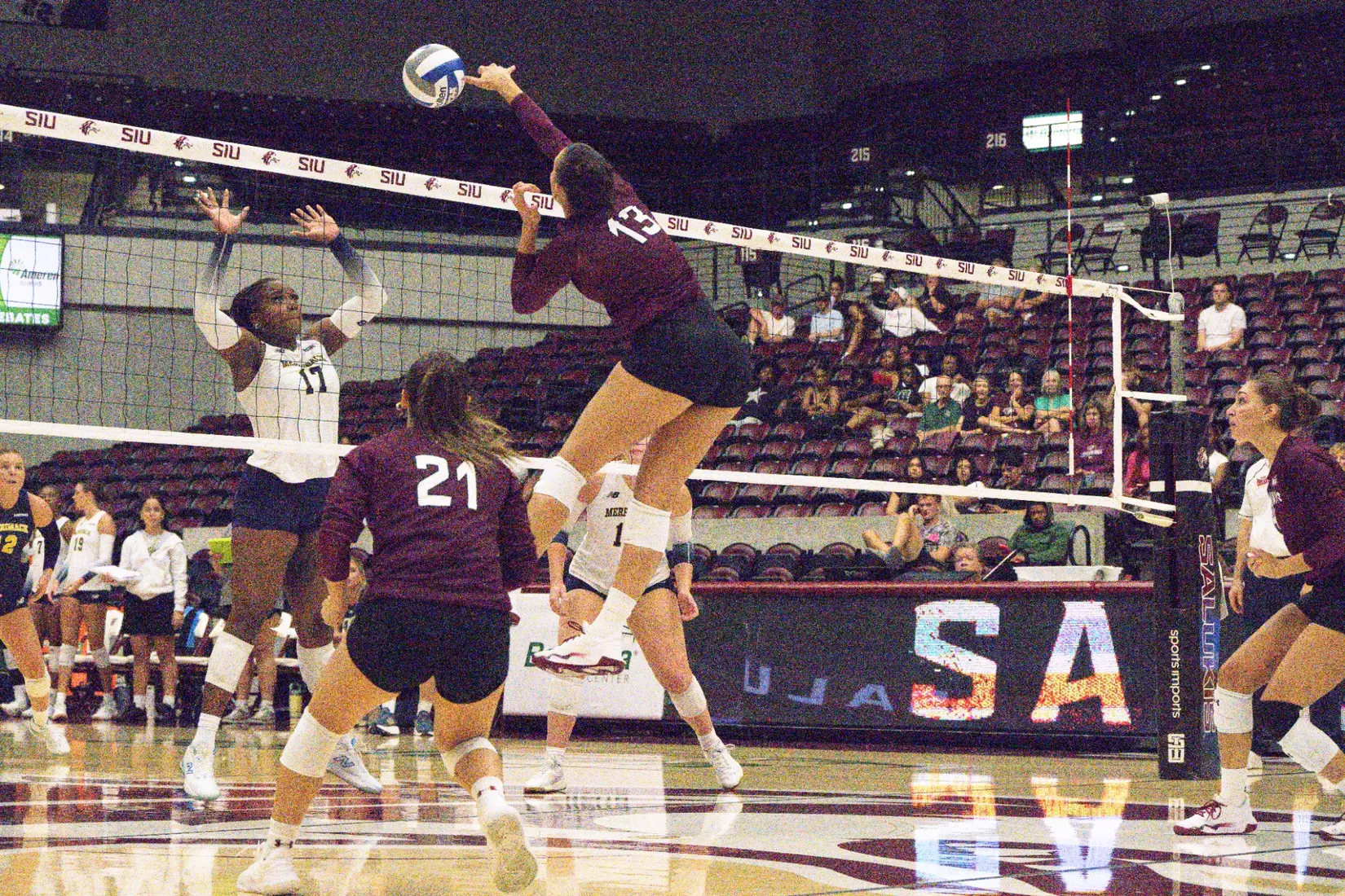 Beatriz Piaia spikes a ball over the net.