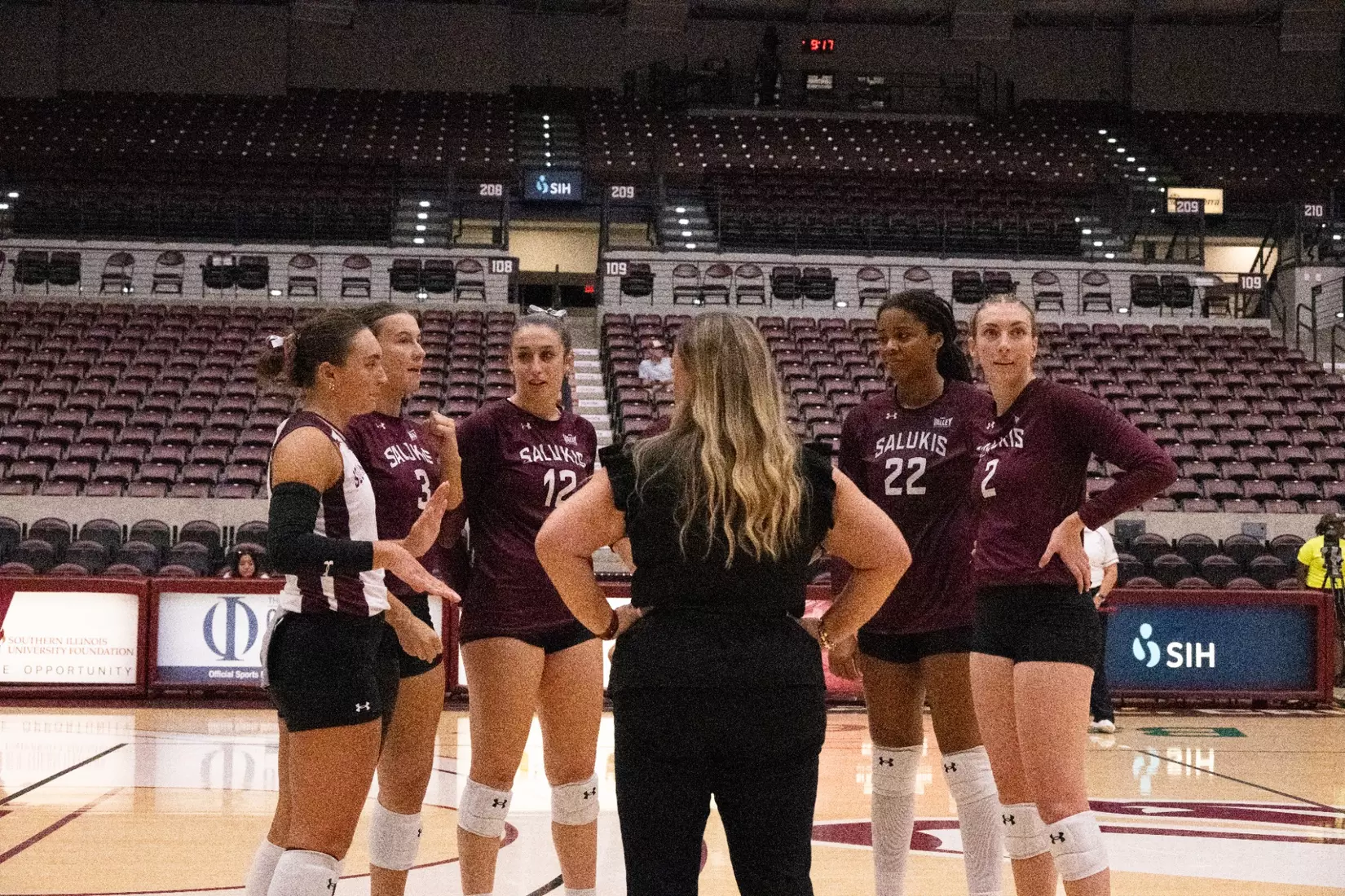 Head Coach Brittany Harry talks to the team on the floor during a challenge.