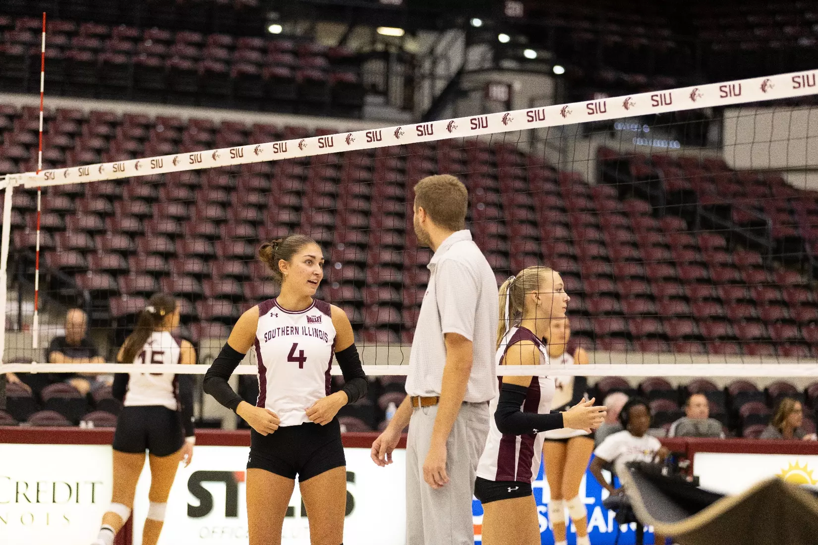 Assistant Coach Chris Yates talks with Ella McFarland in warmups.