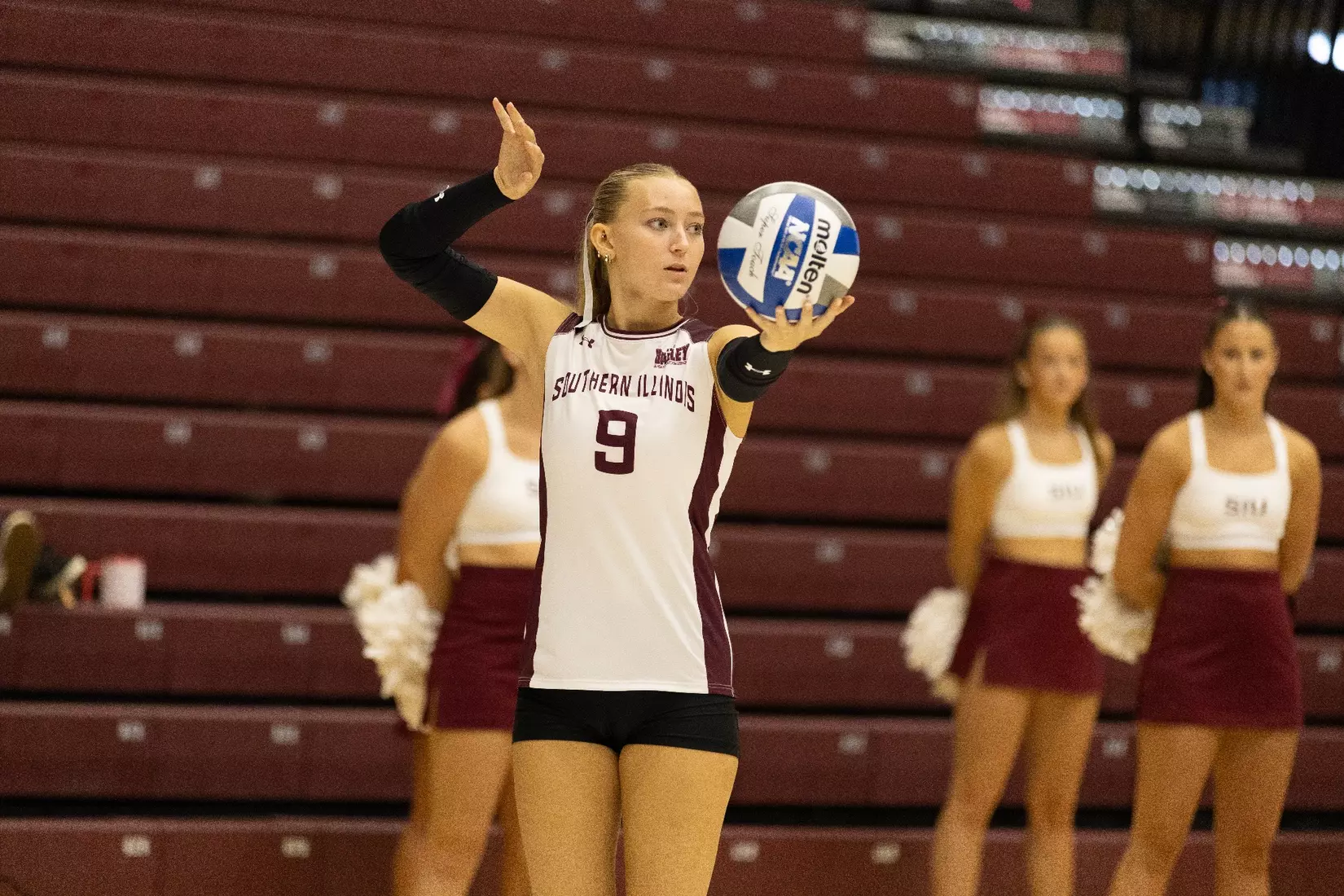 Lillian Dempkey rocks her arm back prior to serving the ball.