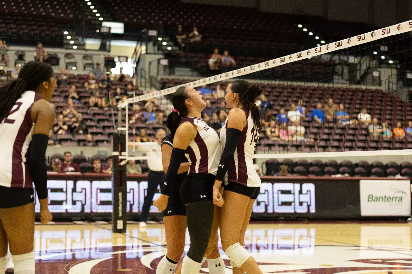 Ella Swansiger and McKenzie Moeller chest bump after a point.
