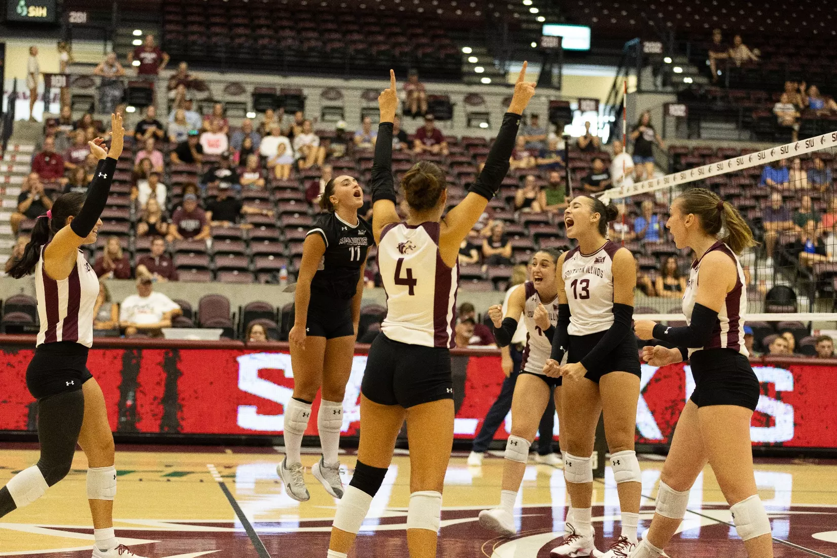 The team jumps, screams, and celebrates after a point.