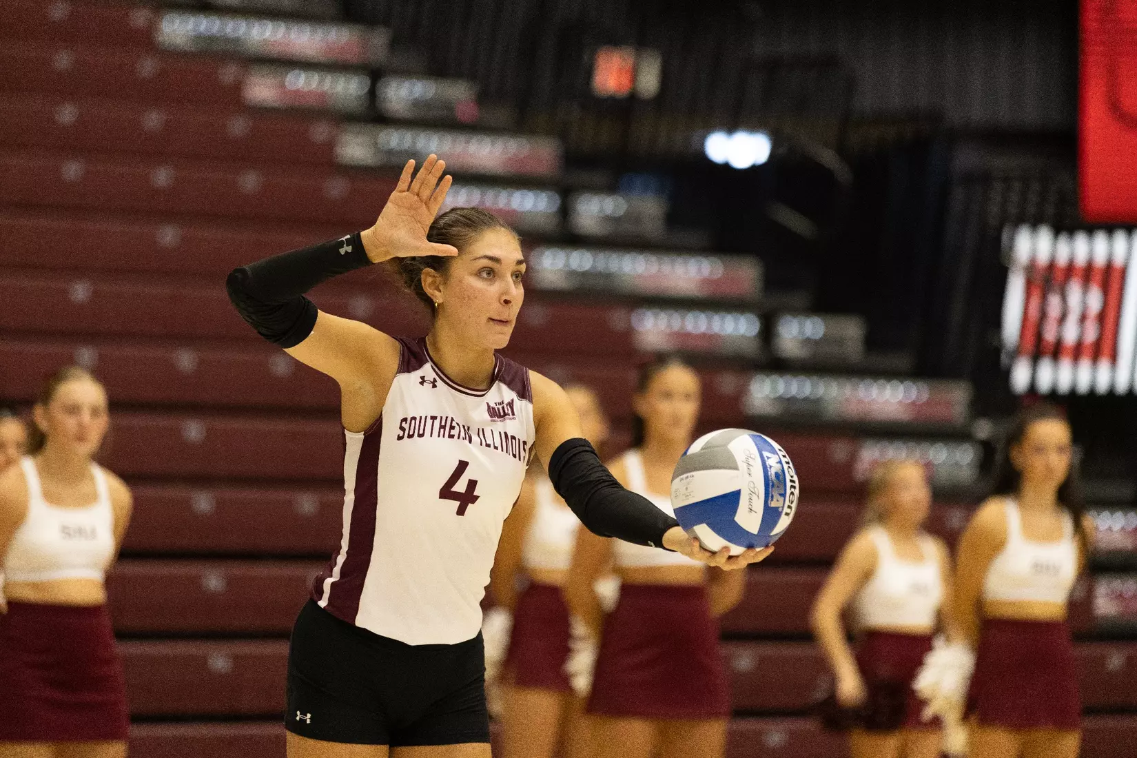 Ella McFarland prepares to serve a ball.