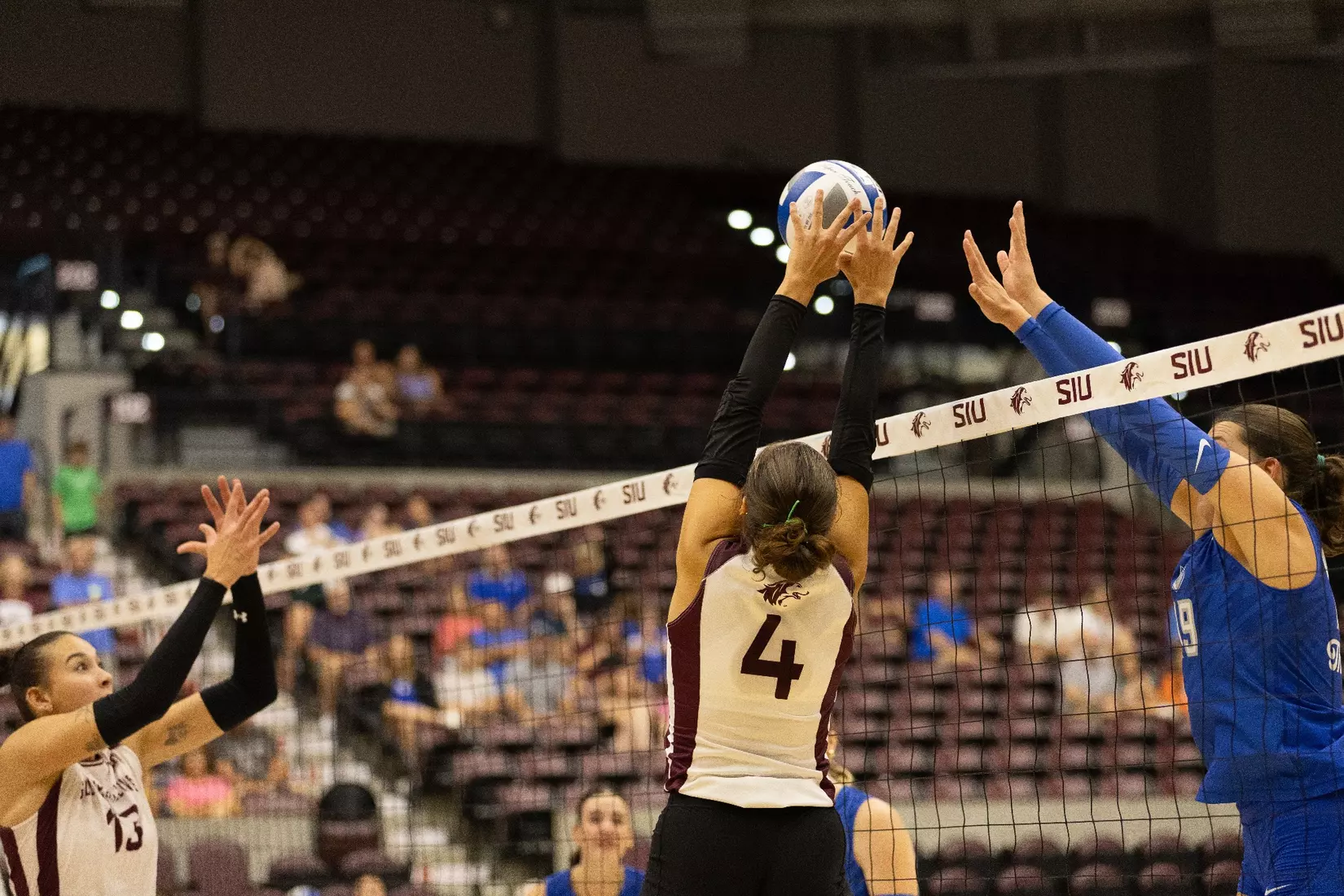Ella McFarland tips a ball over the net.