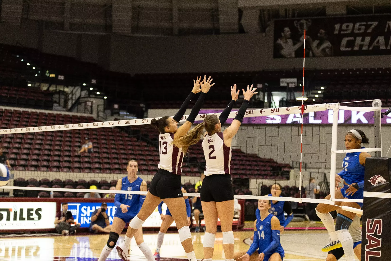 Natalie Vance and Beatriz Piaia jump up for a block.