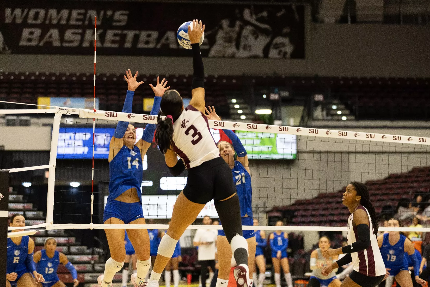 McKenzie Moeller smacks a ball over the net.