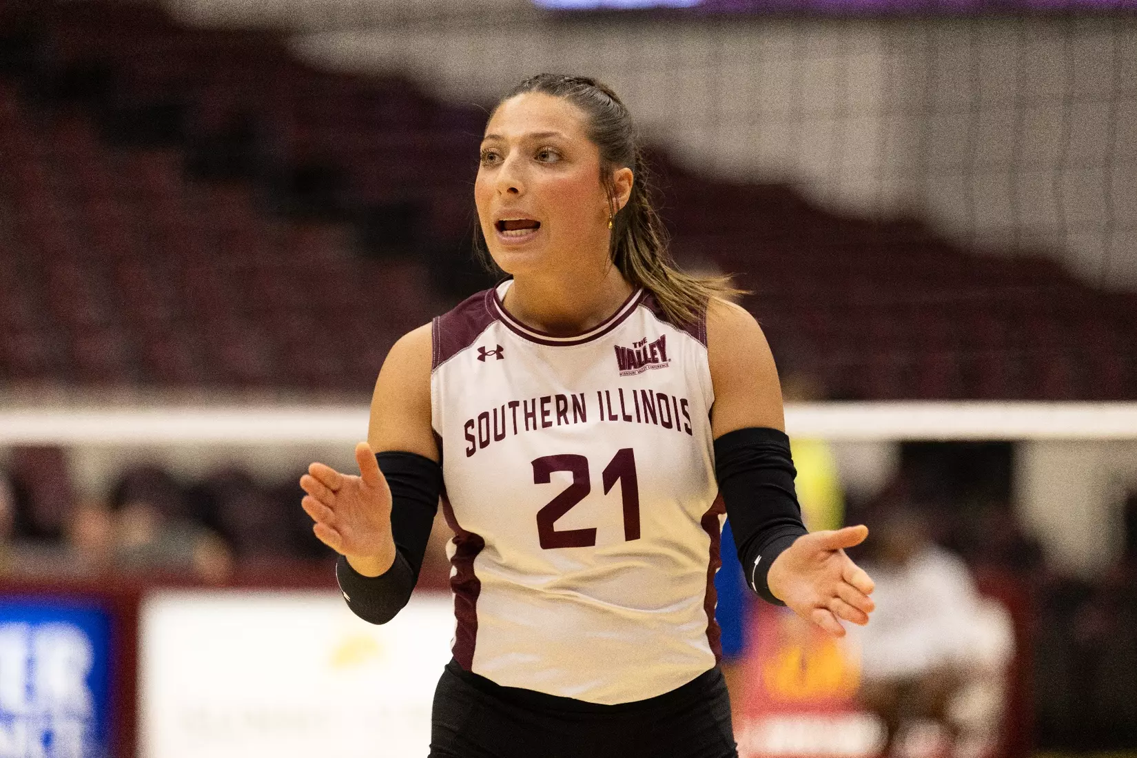 Isabella Del Real begins to clap in support of her teammates.
