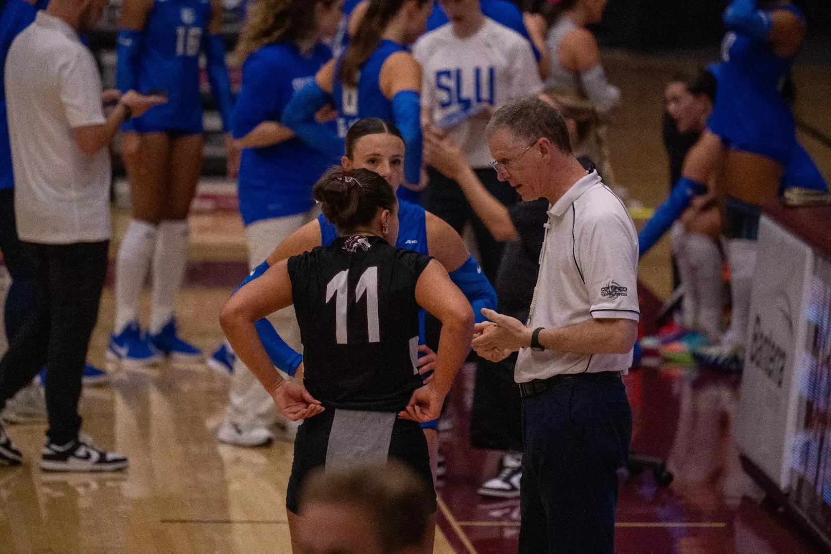 Jillian Shaneyfelt talks with the referee and the opposing team's captain before the match.