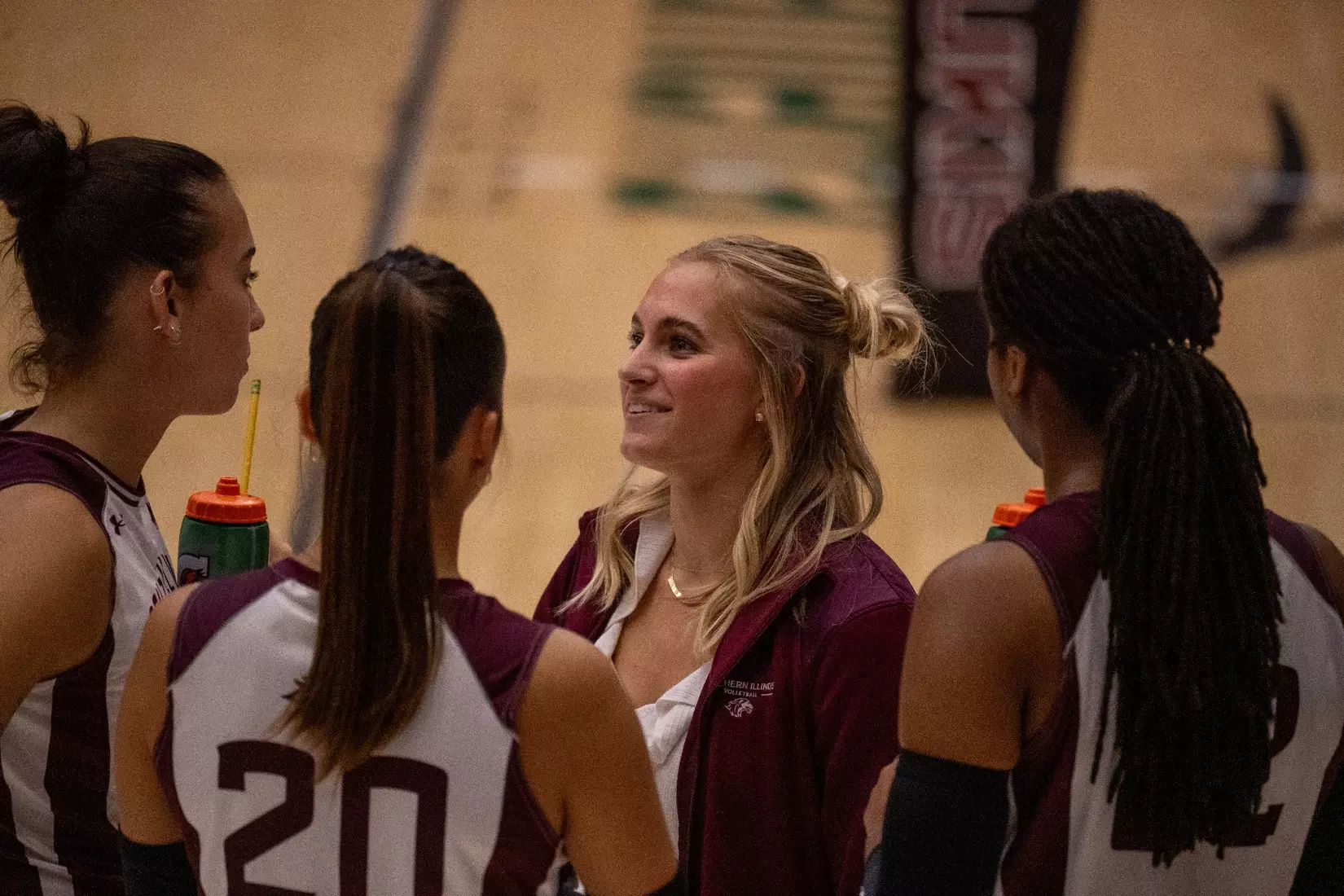 Graduate Assistant Emma Lade talks to members of the team prior to the match.