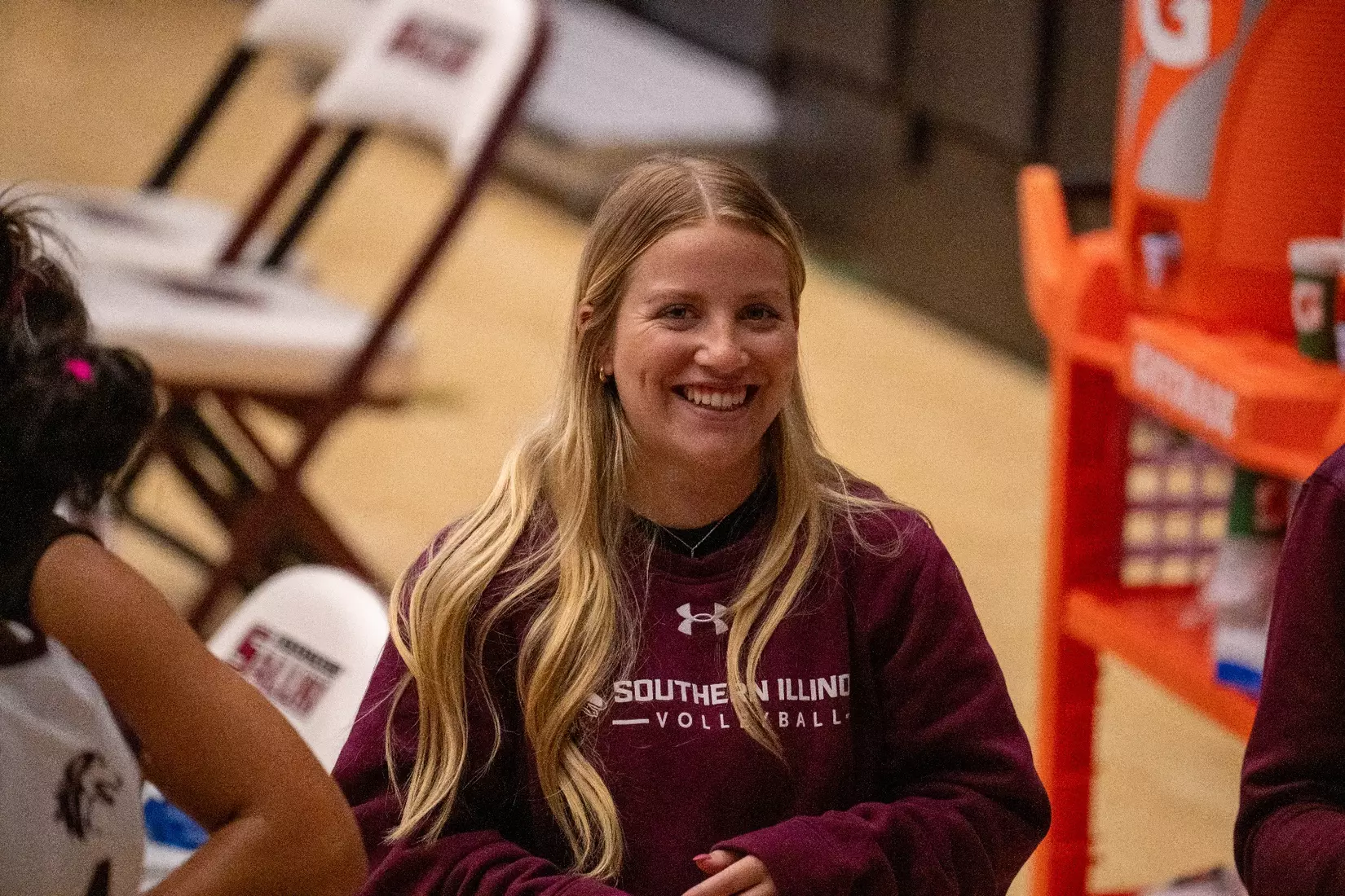 Assistant Athletic Trainer Lexi Tobin smiles as she talks with the team.