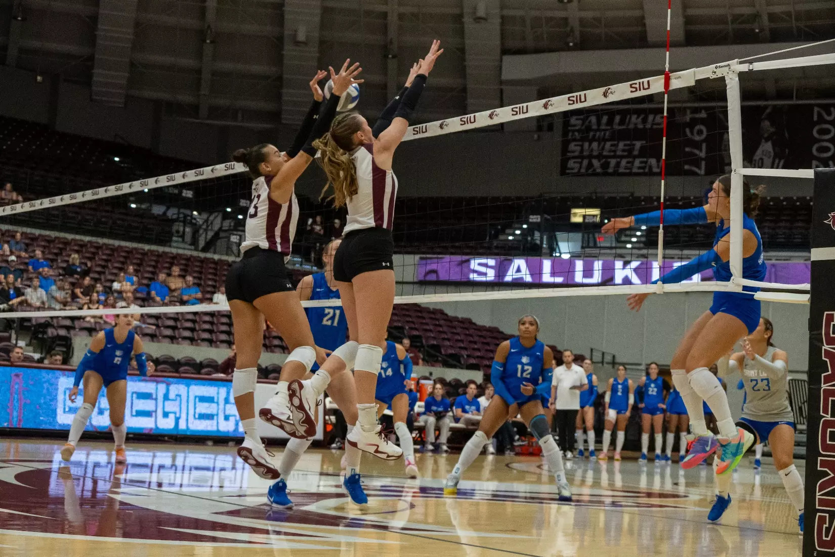 Natalie Vance and Beatriz Piaia jump to block an incoming attack.
