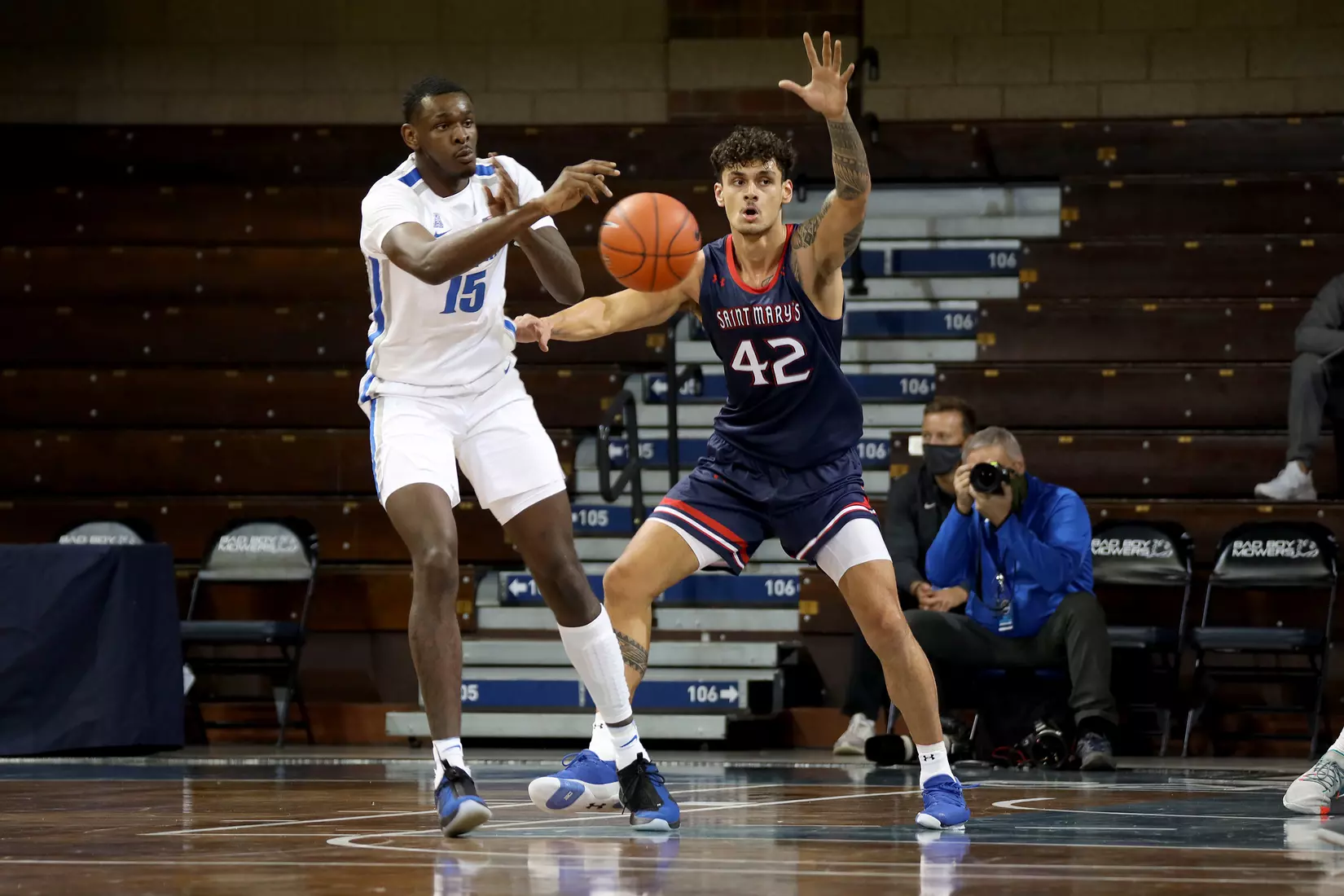Lance Thomas #15 of the Memphis Tigers passes the ball while being pressured by Dan Fotu #42 of the St. Mary's Gaels during the Bad Boy Mowers Crossover Classic at the Sanford Pentagon in Sioux Falls, SD. (Photo by Dave Eggen/Inertia)