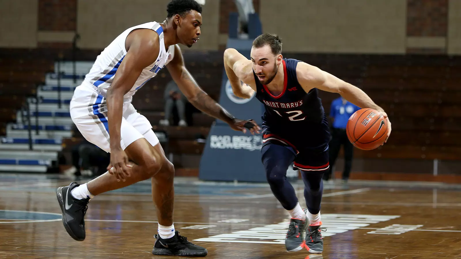 Tommy Kuhse #12 of the St. Mary's Gaels looks to drive past D.J. Jeffries #0 of the Memphis Tigers during the Bad Boy Mowers Crossover Classic at the Sanford Pentagon in Sioux Falls, SD. (Photo by Dave Eggen/Inertia)