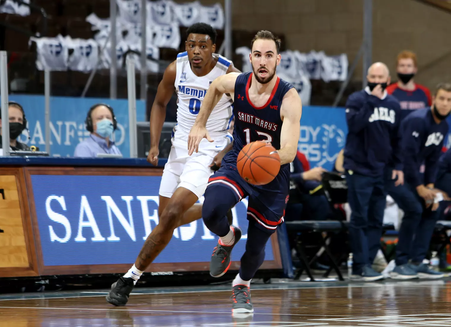 Tommy Kuhse #12 of the St. Mary's Gaels pushes the ball past D.J. Jeffries #0 of the Memphis Tigers during the Bad Boy Mowers Crossover Classic at the Sanford Pentagon in Sioux Falls, SD. (Photo by Dave Eggen/Inertia)