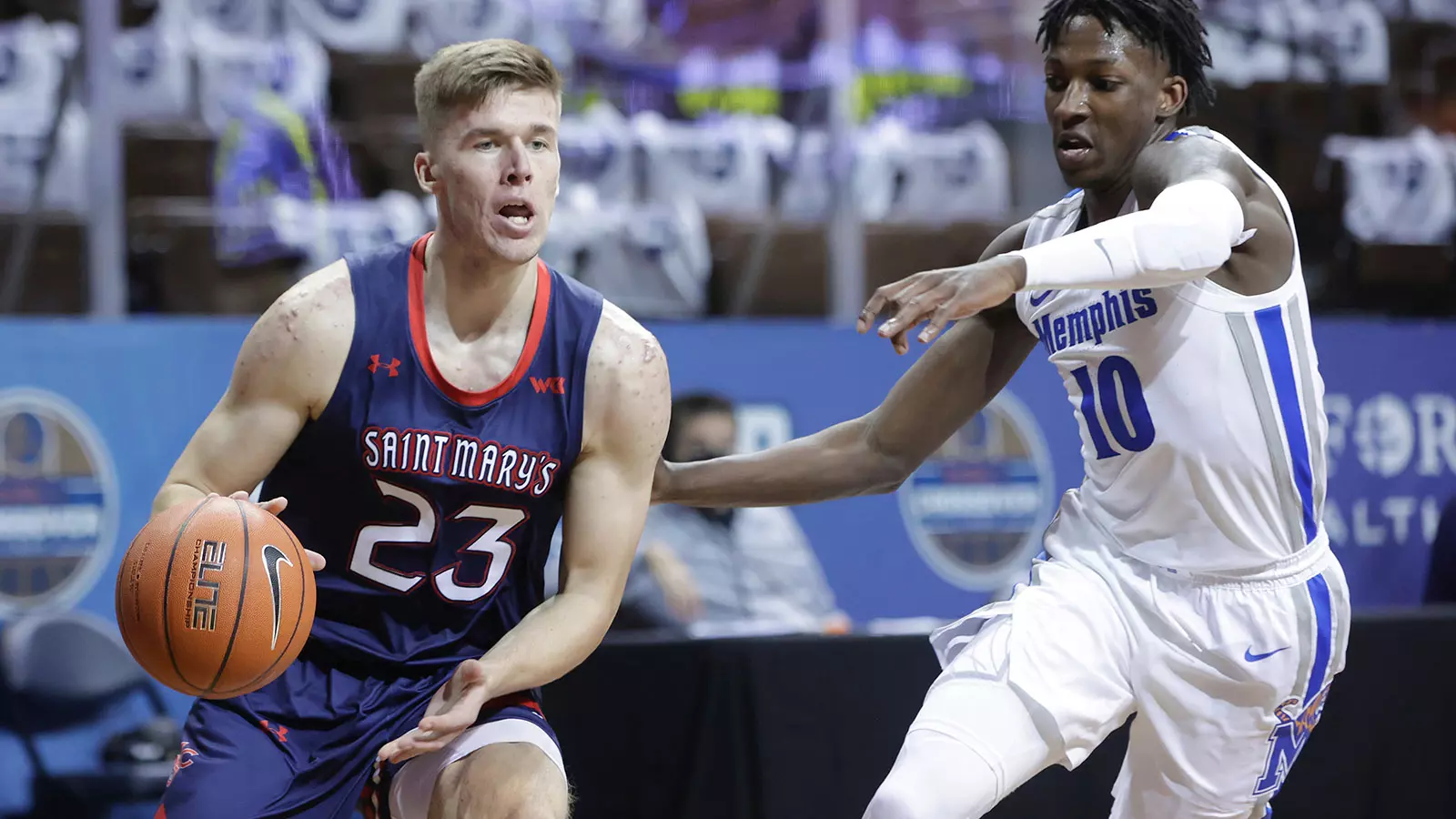 Leemet Böckler #23 of the St. Mary's Gaels drives on Damion Baugh #10 of the Memphis Tigers during the Bad Boy Mowers Crossover Classic at the Sanford Pentagon in Sioux Falls, SD. (Photo by Richard Carlson/Inertia)