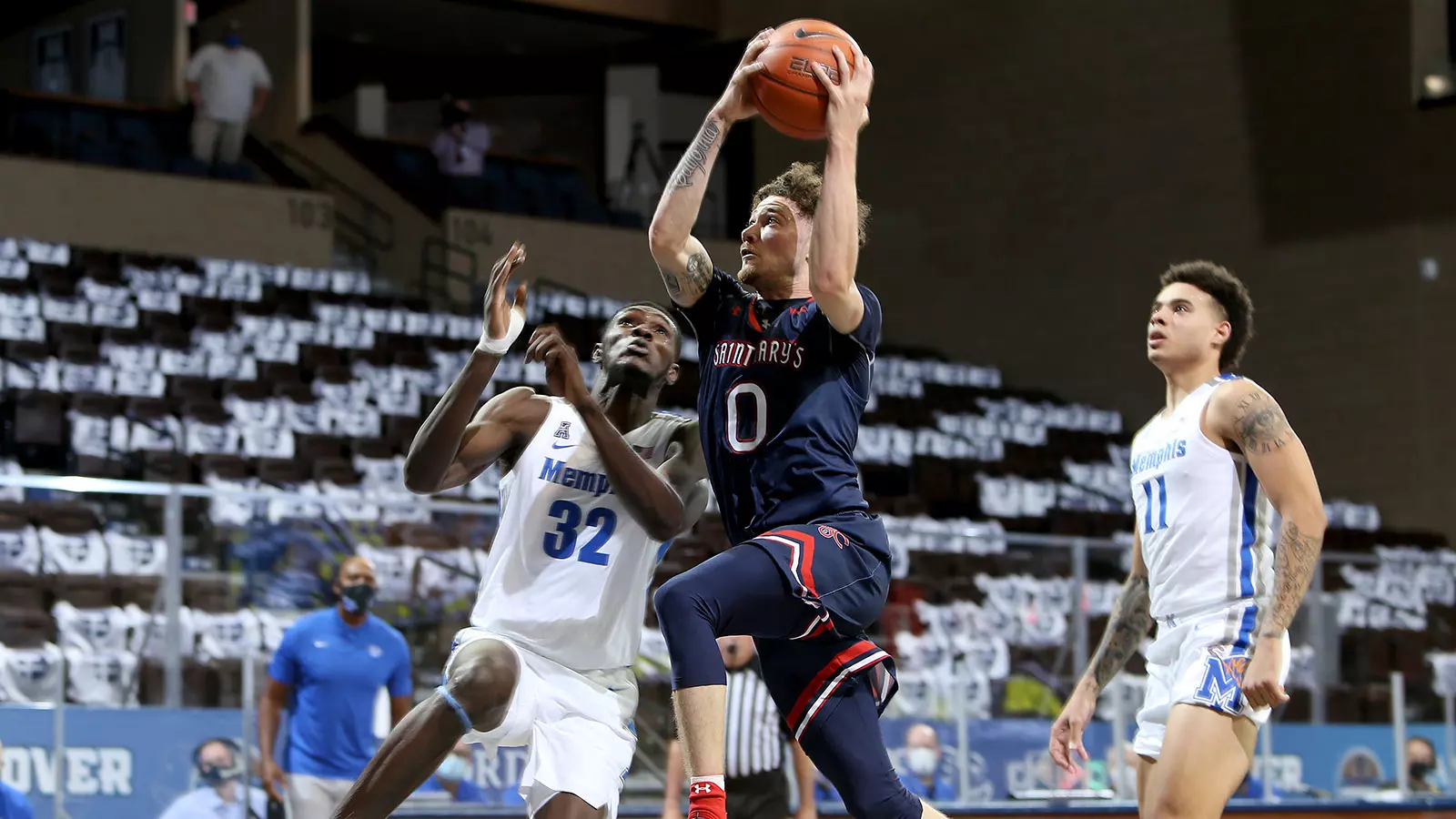 Logan Johnson #0 of the Gaels drives to the basket against Moussa Cisse #32 of the Memphis Tigers during the Bad Boy Mowers Crossover Classic at the Sanford Pentagon in Sioux Falls, SD. (Photo by Dave Eggen/Inertia)