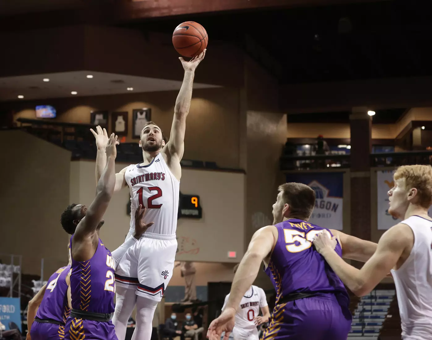 Tommy Kuhse #12 of the St. Mary's Gaels shoots over Northern Iowa defenders during the Bad Boy Mowers Crossover Classic at the Sanford Pentagon in Sioux Falls, SD. (Photo by Richard Carlson/Inertia)