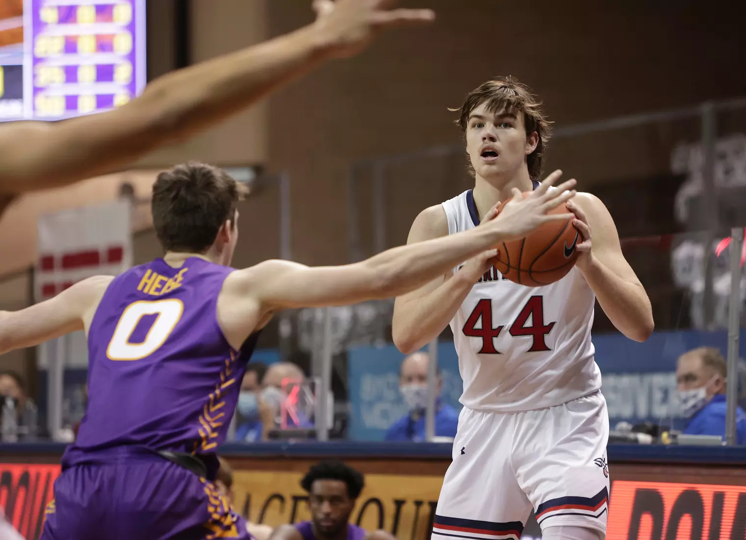 Alex Ducas #44 of the St. Mary's Gaels looks past Nate Heise #0 of the Northern Iowa Panthers during the Bad Boy Mowers Crossover Classic at the Sanford Pentagon in Sioux Falls, SD. (Photo by Richard Carlson/Inertia)