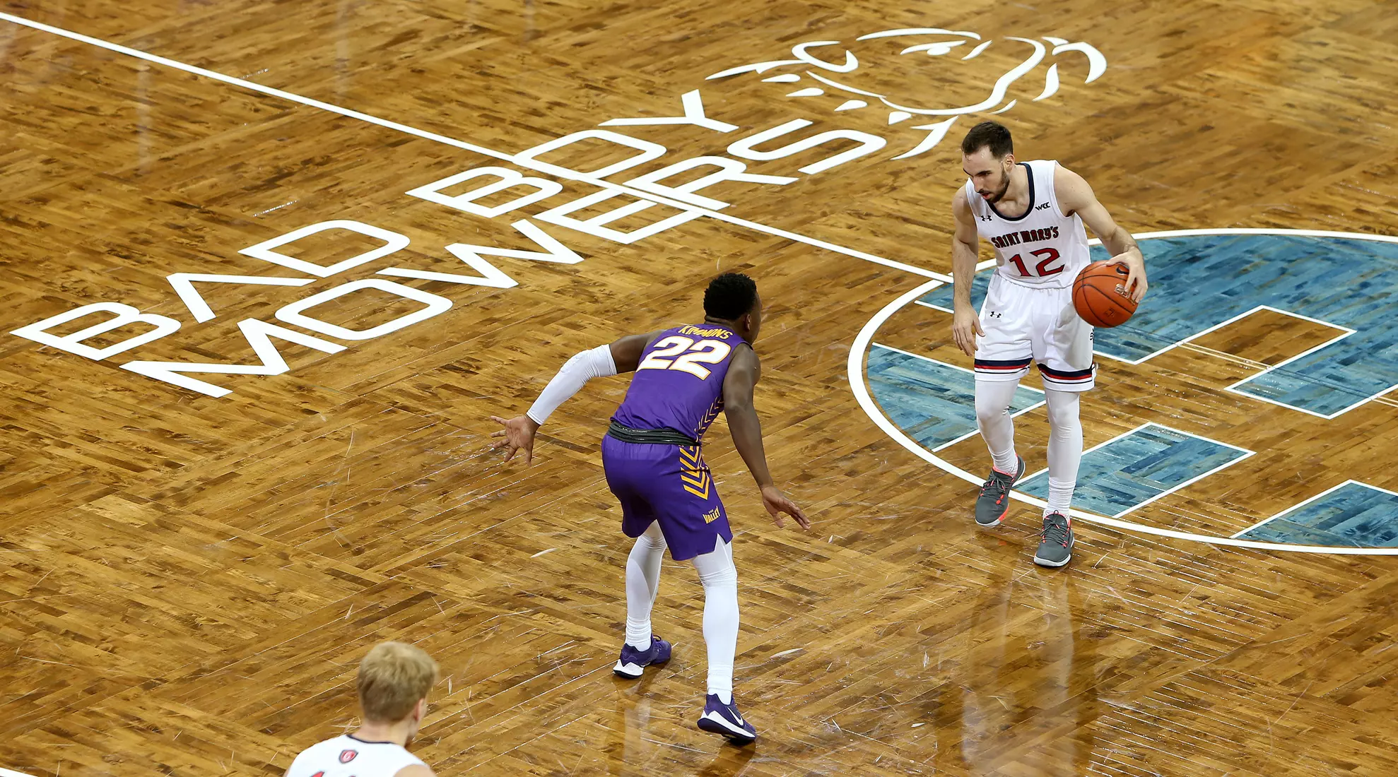 Tommy Kuhse #12 of the St. Mary's Gaels brings the ball up court against Antwan Kimmons #22 of the Northern Iowa Panthers during the Bad Boy Mowers Crossover Classic at the Sanford Pentagon in Sioux Falls, SD. (Photo by Dave Eggen/Inertia)