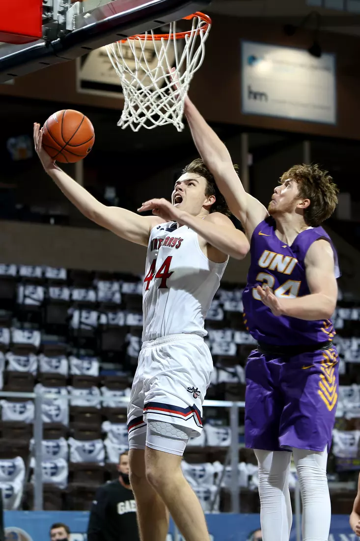 Alex Ducas #44 of the St. Mary's Gaels lays the ball up past James Betz #34 of the Northern Iowa Panthers during the Bad Boy Mowers Crossover Classic at the Sanford Pentagon in Sioux Falls, SD. (Photo by Dave Eggen/Inertia)