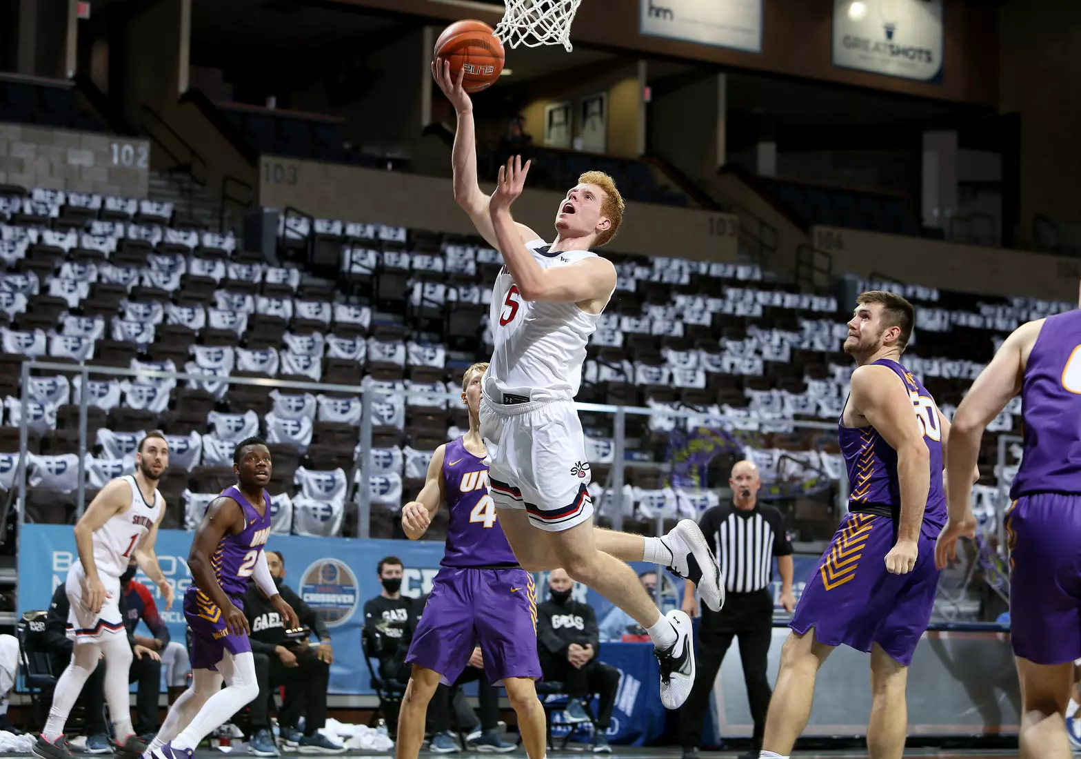 Jabe Mullins #5 of the St. Mary's Gaels lays the ball up against the Northern Iowa Panthers during the Bad Boy Mowers Crossover Classic at the Sanford Pentagon in Sioux Falls, SD. (Photo by Dave Eggen/Inertia)