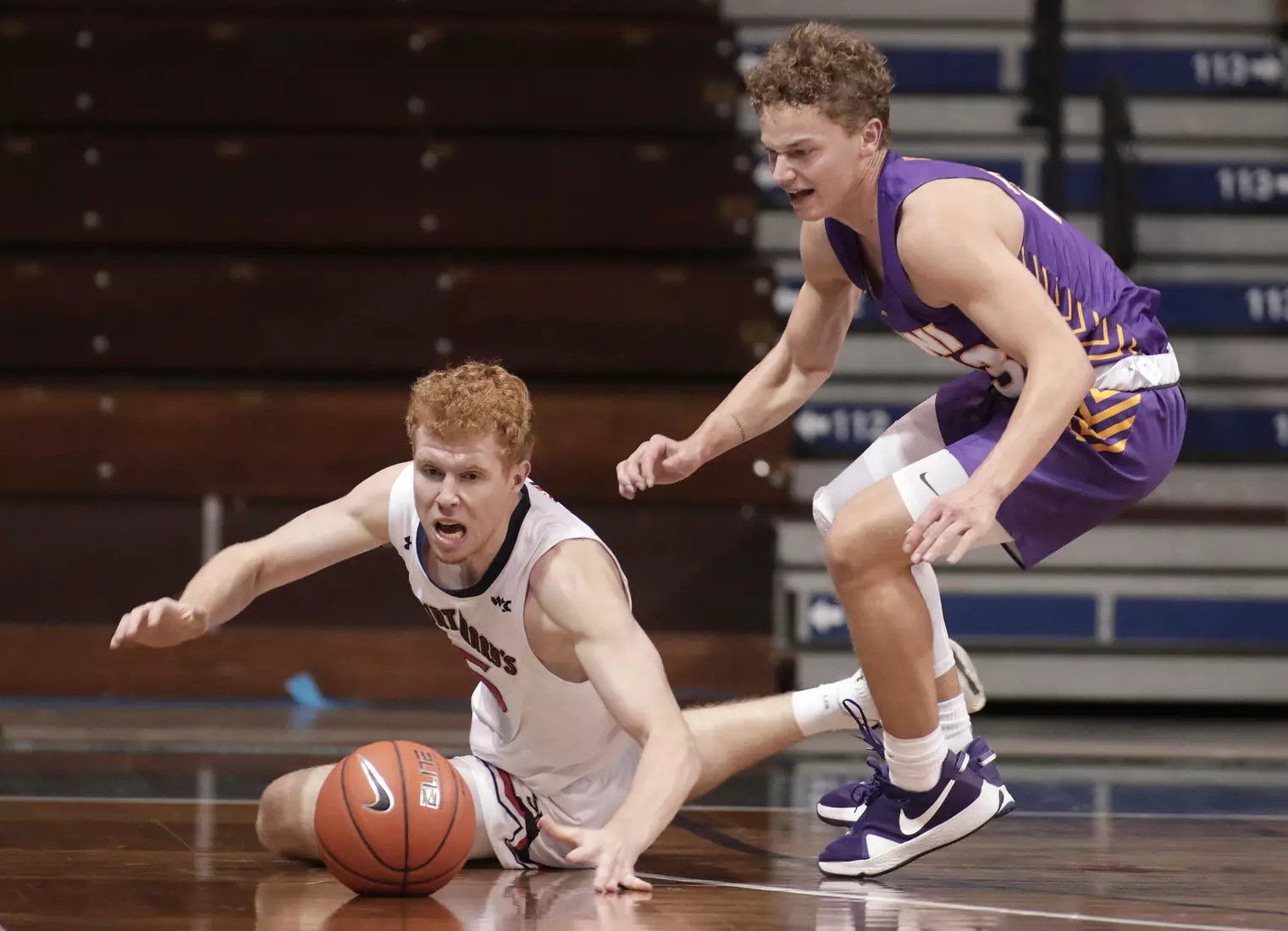 Jabe Mullins #5 of the St. Mary's Gaels and Bowen Born #13 of the Northern Iowa Panthers scramble for a loose ball during the Bad Boy Mowers Crossover Classic at the Sanford Pentagon in Sioux Falls, SD. (Photo by Richard Carlson/Inertia)
