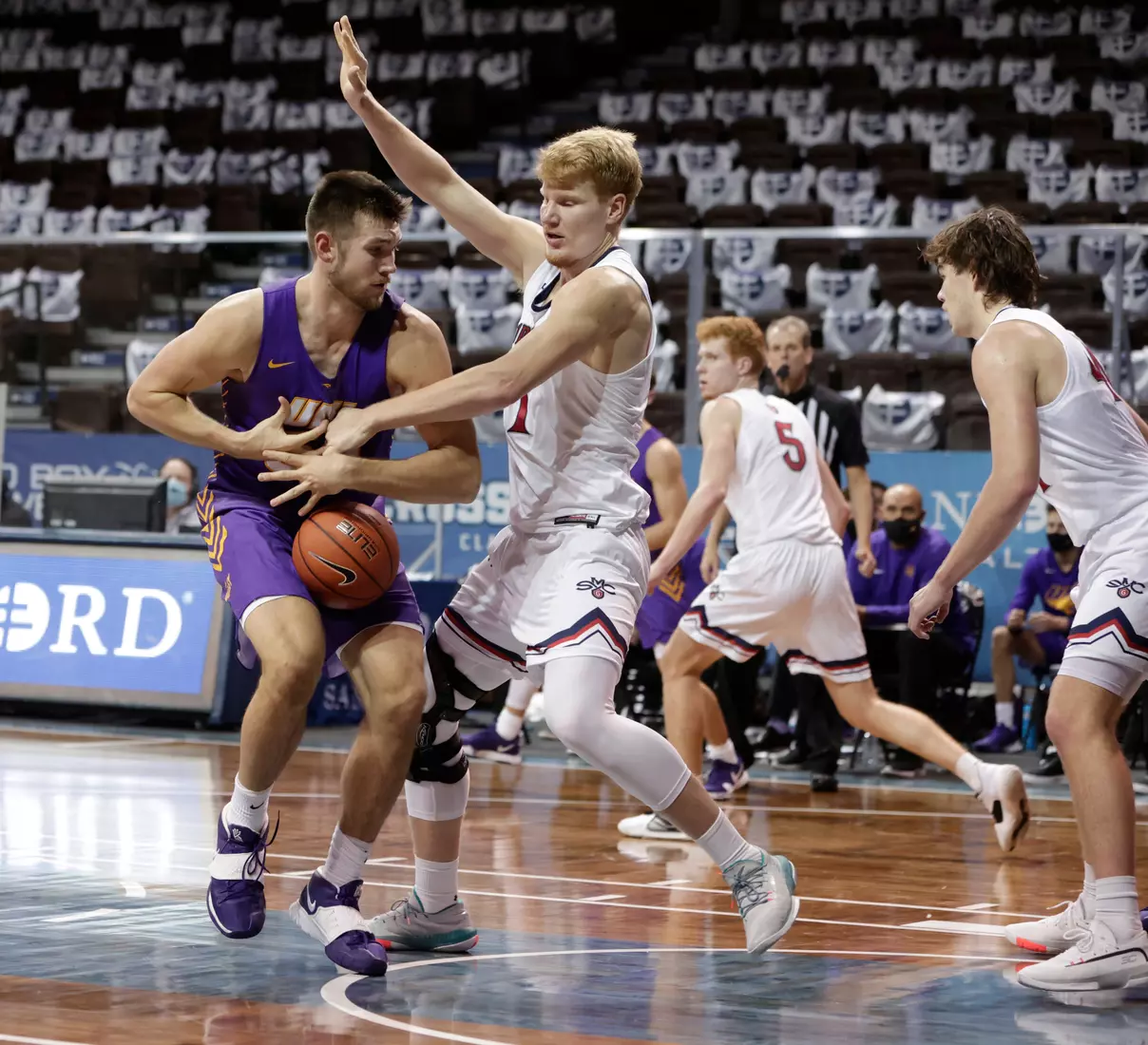 Matthias Tass #11 of the St. Mary's Gaels knocks the ball loose from Austin Phyfe #50 of the Northern Iowa Panthers during the Bad Boy Mowers Crossover Classic at the Sanford Pentagon in Sioux Falls, SD. (Photo by Richard Carlson/Inertia)