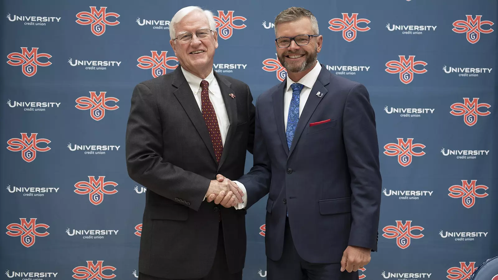 President Donahue (left) and David Tuyo (right) shaking hands.