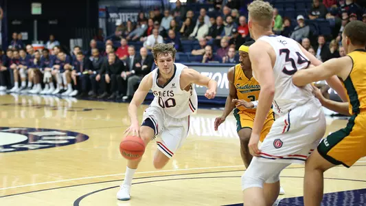 Tanner Krebs (00) dribbles by his defender during the opening half against Southeastern Louisiana in the NIT on March 13, 2018