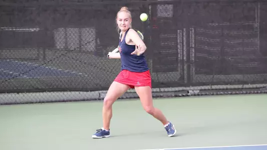 Kozyreva winds up for a forehand swing