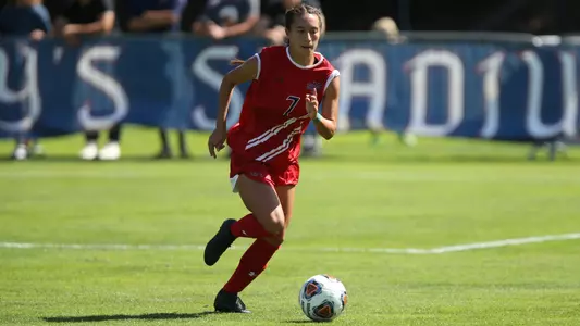 Malia Allison dribbles upfield