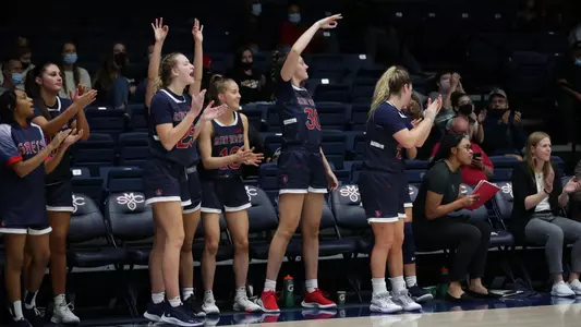 WBB Bench Celebration in blue uniforms