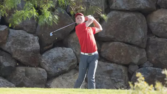 Kristian Bressum in red with rock background