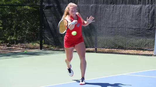 Hovda in red makes a play on the baseline