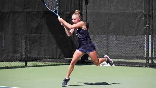 Kozyreva in blue two-handed leaping shot