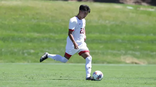 Tyler Hardin strides upfield while dribbling