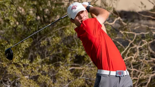 Connor Reis in red following through on tee shot